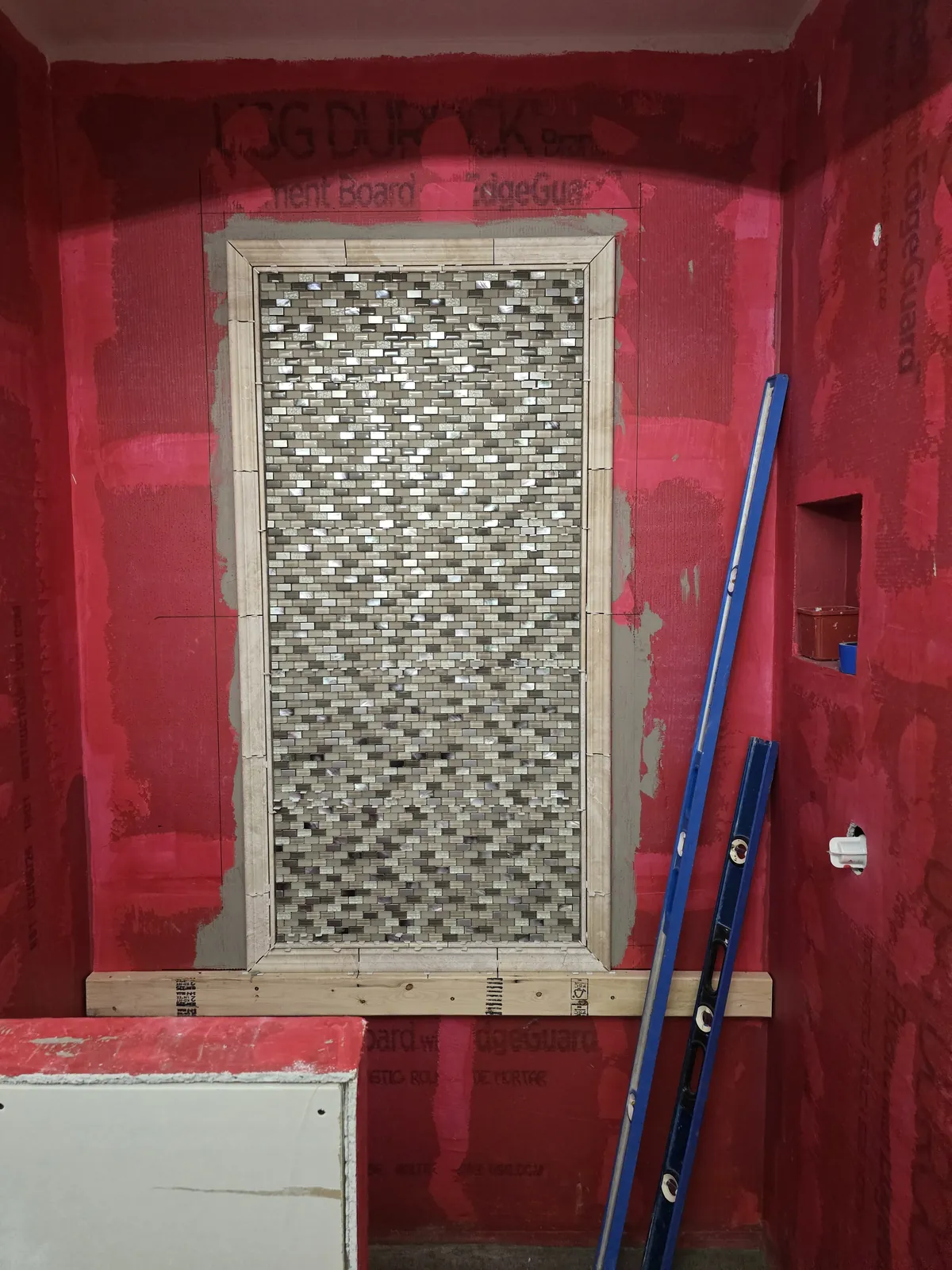 Waterproofing membrane, niche and mosaic accent column installed before tile